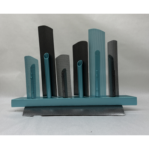 horizontal display of gray and ice blue metal spires emanating from ice blue horizontal base that sits on a textural gray base.