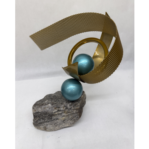 brassy gold coated steel bands with aqua spheres separating the steel band; mounted on stone